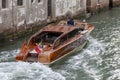 Wooden retro boat taxi in Venice on a summer day