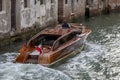 Wooden retro boat taxi in Venice on a summer day