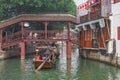 Wooden retro boats move along the houses in ancient town