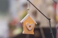 Wooden retro decor in the form of a house with a heart