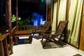 Wooden retro furniture. Old wooden table and chairs, stand on the porch of a bungalow house. On the street at night Royalty Free Stock Photo