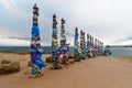 Wooden ritual pillars with colorful ribbons Hadak on cape Burkhan. Lake Baikal. Olkhon Island. Russia Royalty Free Stock Photo