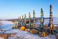 Wooden ritual pillars with colorful ribbons