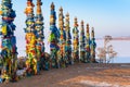 Wooden ritual pillars with colorful ribbons