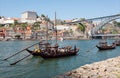 Wooden riverboats with wine barrels and port wine, old wineries boats for advertising on river Douro Royalty Free Stock Photo
