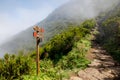 Wooden road destination sign near Pico Ruivo at the highest walking tourist path of Madeira island. Royalty Free Stock Photo
