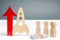 Wooden rocket and up arrow. The concept of a startup. The concept of raising fund for a startup. Charitable contributions to