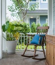 Wooden rocking chair on front porch with pillow Royalty Free Stock Photo