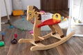 Wooden rocking horse. Children toy in messy children`s room Royalty Free Stock Photo