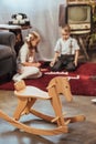 wooden rocking horse and little kids playing with domino tiles at home Royalty Free Stock Photo