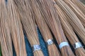 Wooden rods bunch. Rustic broom for sale on market table. Natural material for household broom. Rustic wooden sticks Royalty Free Stock Photo