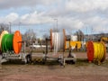 Wooden rollers with multi-colored fiber optic cables for laying data cables on a construction site. Royalty Free Stock Photo