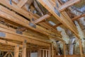 Wooden roof beams with insulates the attic with pipe heating system and mineral wool Royalty Free Stock Photo