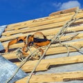 Wooden roof construction and Equipment for work at height, symbolic photo for home, house building Equipment for work at height Royalty Free Stock Photo