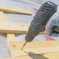 Wooden roof construction and screwdriver, symbolic photo for home, house building Royalty Free Stock Photo