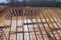 Wooden roof framework consists of trusses beams that were built while constructing a new beam stick home.