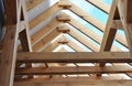 Wooden roof framing with a close-up of rafters, roof beams and purlins framing during roofing construction