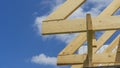 Wooden roof with rafter style framing against a blue sky Royalty Free Stock Photo