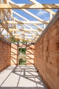 Wooden roof with support beams and ceilings in new brick house under construction Royalty Free Stock Photo