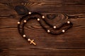 Wooden rosary beads with cross, top view. Christian concept Royalty Free Stock Photo