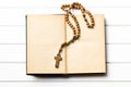 Wooden rosary beads with old book Royalty Free Stock Photo