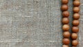 Wooden beads on a rough cloth Royalty Free Stock Photo