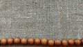 Wooden rosary on canvas top view. Royalty Free Stock Photo