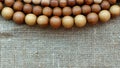 Wooden rosary on canvas top view. Royalty Free Stock Photo