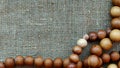 Wooden rosary on canvas top view. Wooden beads Royalty Free Stock Photo