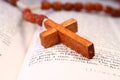 Wooden Rosary Cross on an Open Bible Royalty Free Stock Photo
