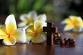 Wooden rosary with Jesus Christ holy cross crucifix and Bali frangipani flowers decoration background. Catholic symbol. Royalty Free Stock Photo