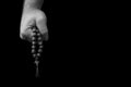 Wooden rosary in the man`s hand Royalty Free Stock Photo