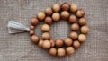 Wooden rosary top view on canvas Royalty Free Stock Photo