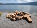 Wooden rosary on wood with Jesus Christ Cross Crucifix. Christian Catholic religious symbol of faith concept. Copy space for your