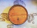 Wooden round barrel with a tap in the wall with decorative plaster. Closeup photo