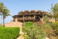 Wooden round building on the beach by the Red Sea. Atypical shape restaurant in Egypt. Exterior view of a pub made of natural