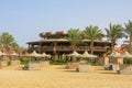 Wooden round building on the beach by the Red Sea. Atypical shape restaurant in Egypt. Exterior view of a pub made of natural