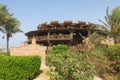Wooden round building on the beach by the Red Sea. Atypical shape restaurant in Egypt. Exterior view of a pub made of natural