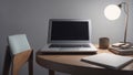 on wooden round desktop, a laptop, a table lamp, a cup and notebooks