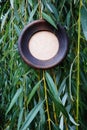 Wooden round frame on a background of willow leaves.
