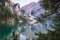 Wooden rowing boats at calm lake Braies or Pragser Wildsee during sunset pink light. Dolomites, Italy Royalty Free Stock Photo