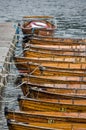 Wooden rowing boats moored up against a jetty in the Cotswolds Royalty Free Stock Photo