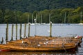 Wooden rowing boats moored up against a jetty in the Cotswolds Royalty Free Stock Photo
