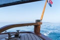 Wooden rudder on small wooden boat and blue sea Royalty Free Stock Photo