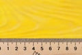 Wooden ruler close up on yellow background. Royalty Free Stock Photo
