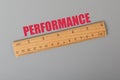Wooden ruler with text PERFORMANCE. Performance concept Royalty Free Stock Photo