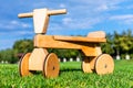 Wooden runbike on the grass field outdoors Royalty Free Stock Photo