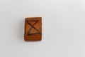 Wooden rune which means day, lie on a table on a white background Royalty Free Stock Photo