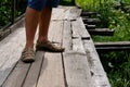 Wooden rural bridge over a river in green woods for tourists to walk along. Wood pathways. Tourist walk Royalty Free Stock Photo