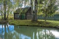 Wooden Russian bath on the shore of a small pond in the village of Vyatka, Yaroslavl region. Royalty Free Stock Photo